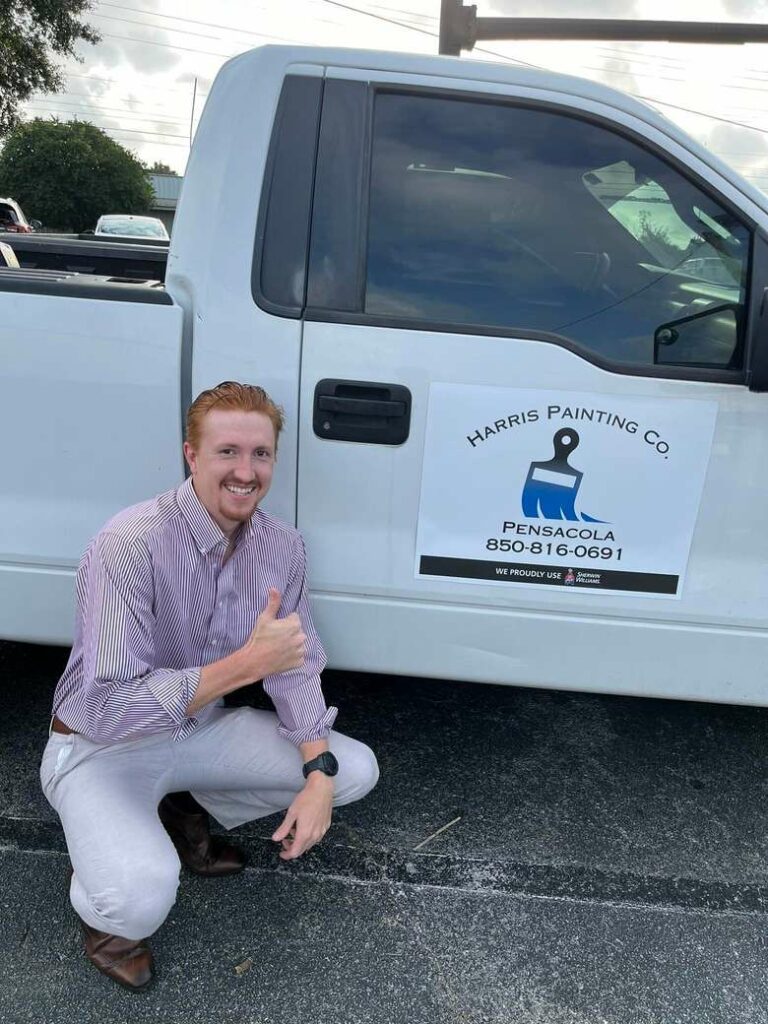 Harris Painting Co. owner Sam standing in front of a company truck, showcasing our commitment to quality service in Pensacola.